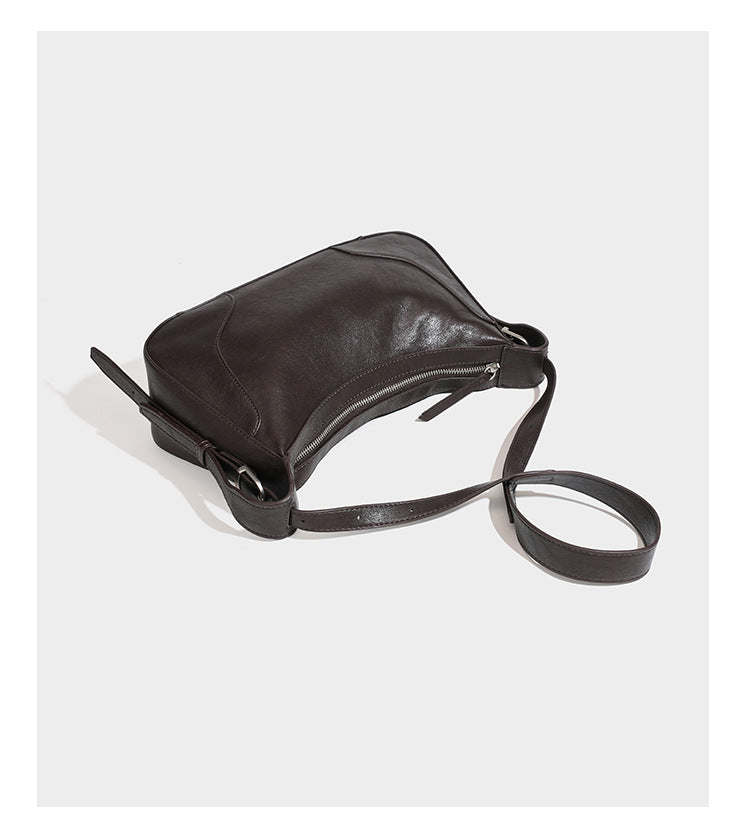 Slouchy crescent hobo shoulder bag in dark brown pebbled leather-look finish with zip top and long shoulder strap, detail