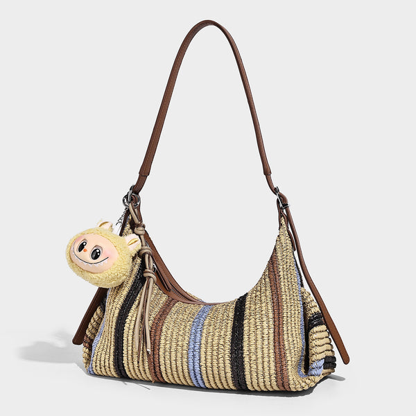 Slouchy woven straw hobo shoulder bag with beige, black, brown, and blue vertical stripes and brown leather-look trim, front