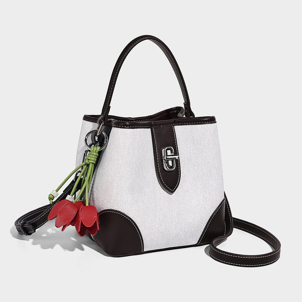 Small structured bucket bag in denim-look light blue fabric with black leather-look trim, silver turn-lock hardware, short