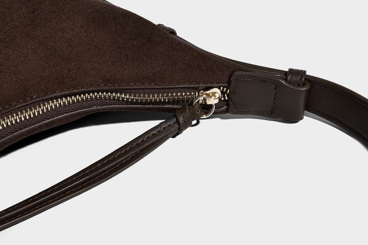 Dark brown suede-look hobo shoulder bag with top zip closure, adjustable strap, and small detachable mini pouch, detail view