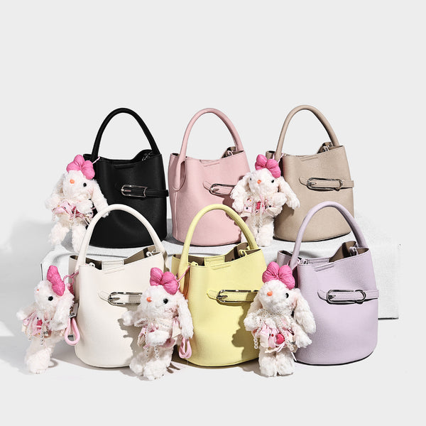Mini pebbled leather-look bucket bag with front buckle strap, silver-tone hardware, top handle, and detachable shoulder