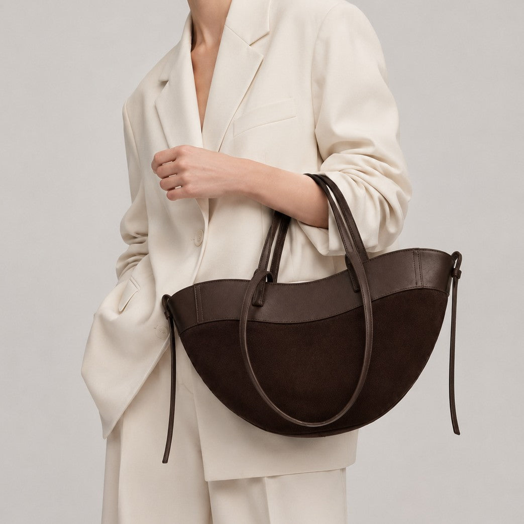 Half-moon crescent tote bag with matte suede-texture lower body and smooth leather-look upper panel, double top handles and