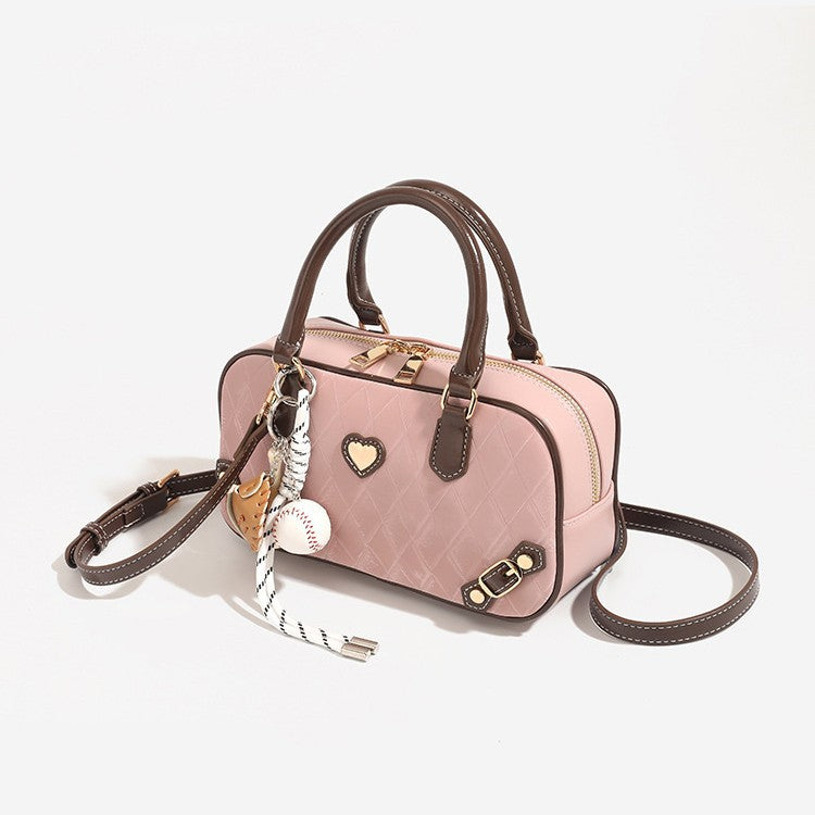 Small structured blush pink quilted diamond Boston barrel bag with brown leather-look trim, double top handles, heart accent
