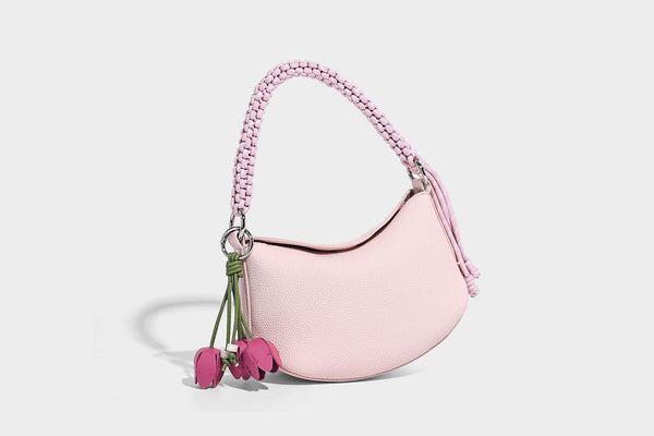 Small crescent half-moon bag in pebbled leather-look finish with braided top handle, silver-tone ring hardware, and, detail