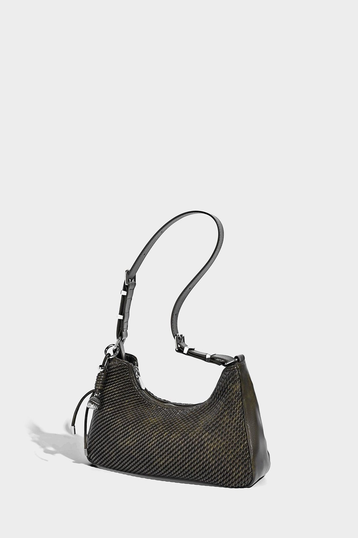 Woven crescent hobo shoulder bag with smooth side panels, zip-top closure, silver-tone charm hardware, and adjustable, detail
