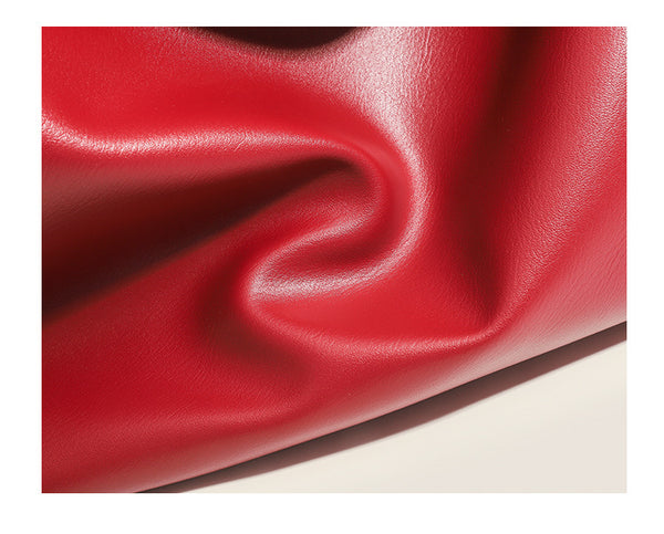 Large slouchy hobo shoulder bag in smooth leather-look finish with single long strap and gold-tone zip closure, detail view