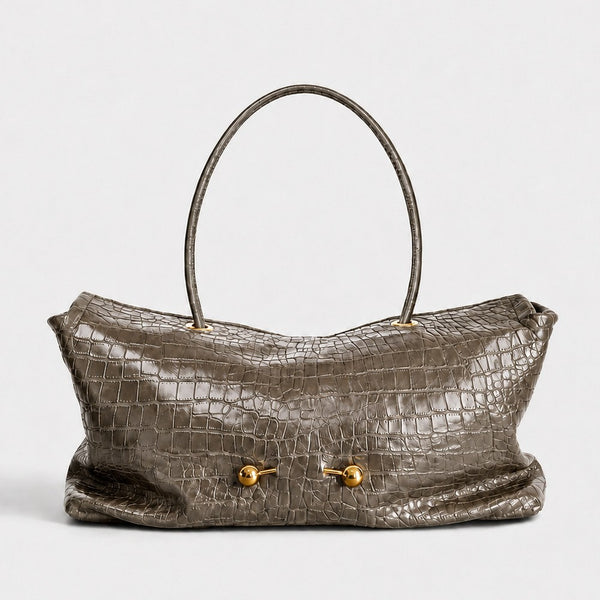 Wide embossed-texture shoulder tote bag with single loop handle and gold-tone toggle hardware, front view