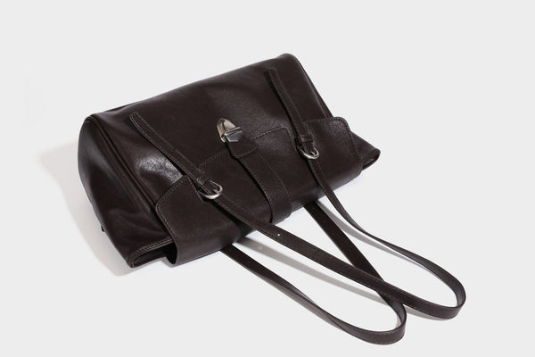 Large structured vintage-style tote bag with flap-front turn-lock closure, twin buckle straps, and double shoulder handles