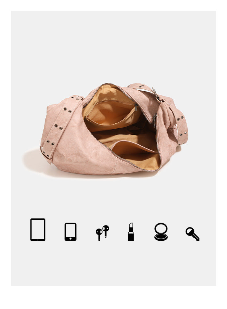 Crescent hobo shoulder bag in matte leather-look finish with star stud front panel, antique-silver hook hardware, and, detail