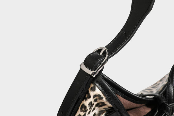 Slouchy leopard print shoulder hobo bag with black leather-look trim, tie-top closure, and single long strap, detail view 38