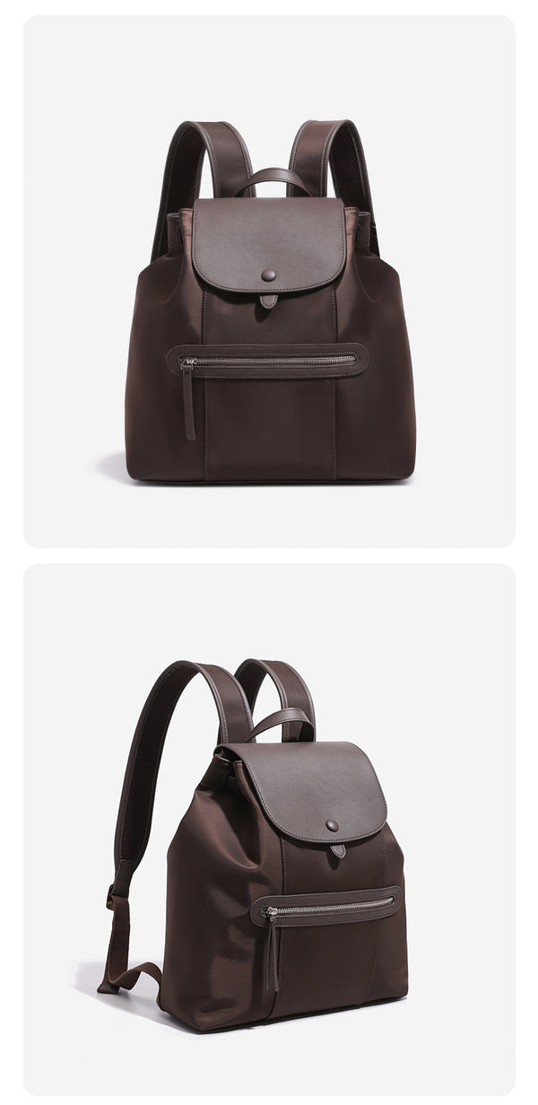Large flap-top nylon backpack with leather-look trim, snap closure, front zip pocket, and padded shoulder straps, detail view