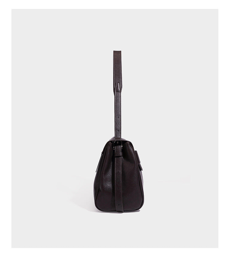 Structured rectangular flap shoulder bag in dark brown leather-look finish with long single strap and layered front panel