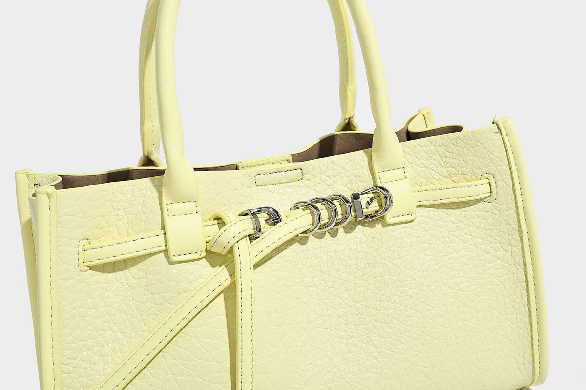 Structured trapezoid tote bag in pebbled leather-look finish with double top handles, silver-tone bar hardware, and, detail