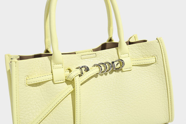 Structured trapezoid tote bag in pebbled leather-look finish with double top handles, silver-tone bar hardware, and, detail