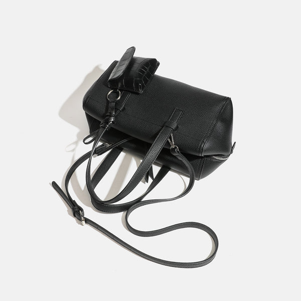 Structured pebbled leather-look top-zip barrel bag with dual handles, detachable shoulder strap, and attached croc-pattern