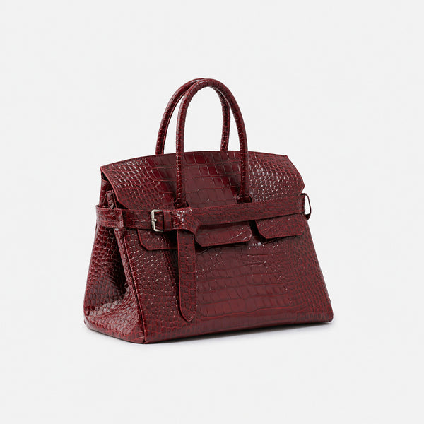Large structured tote satchel with glossy crocodile-embossed leather-look finish, dual top handles, and metal buckle flap