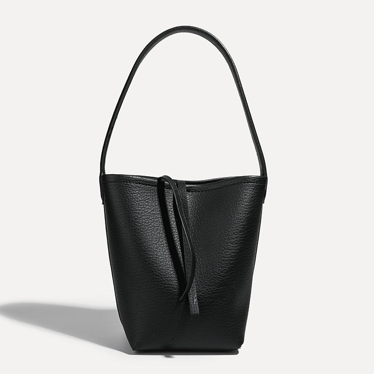 Mini tapered bucket bag in pebbled leather-look finish with front tie straps and single shoulder strap, detail view 12