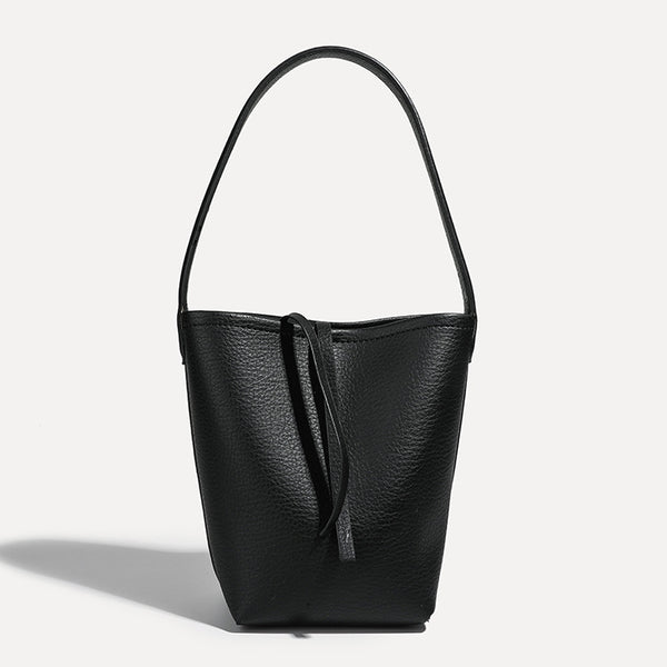 Mini tapered bucket bag in pebbled leather-look finish with front tie straps and single shoulder strap, detail view 12