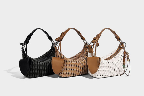 Woven crescent shoulder bag with leather-look knotted handle, zip top, attached mini pouch, and silver-tone hardware, detail