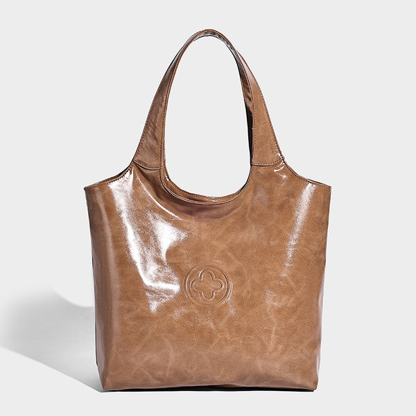 Glossy oil-wax leather-look open-top tote shoulder bag with embossed circular logo and long double straps, detail view 3