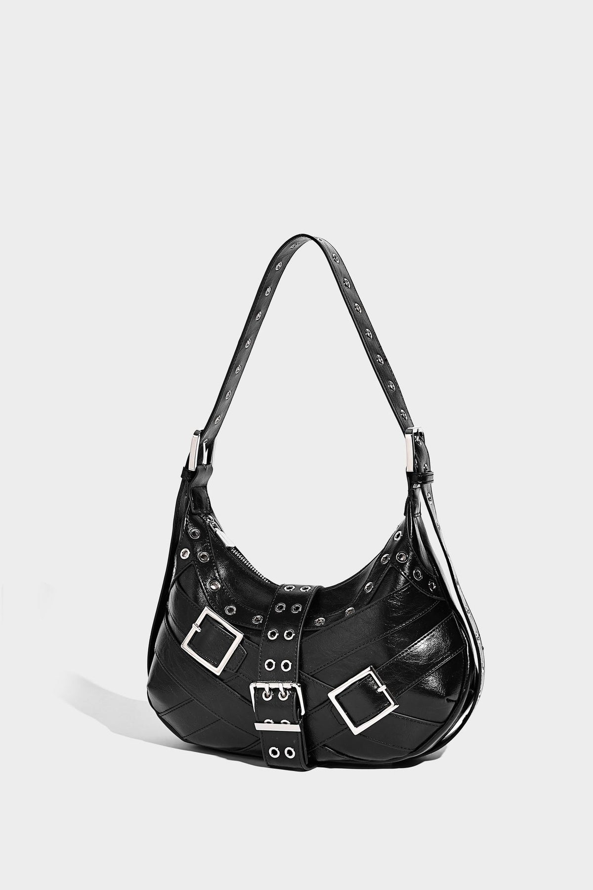 Glossy crescent hobo bag with silver-tone grommets, square buckle straps, and top zipper closure, detail view 17