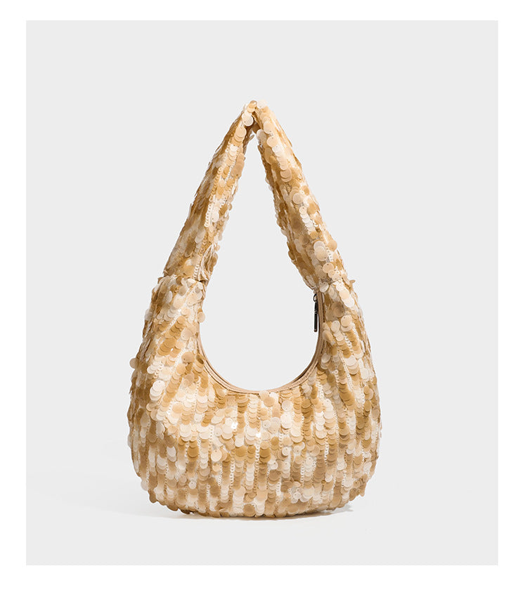 Slouchy crescent hobo shoulder bag covered in overlapping reflective sequin discs with a single integrated strap and top-zip