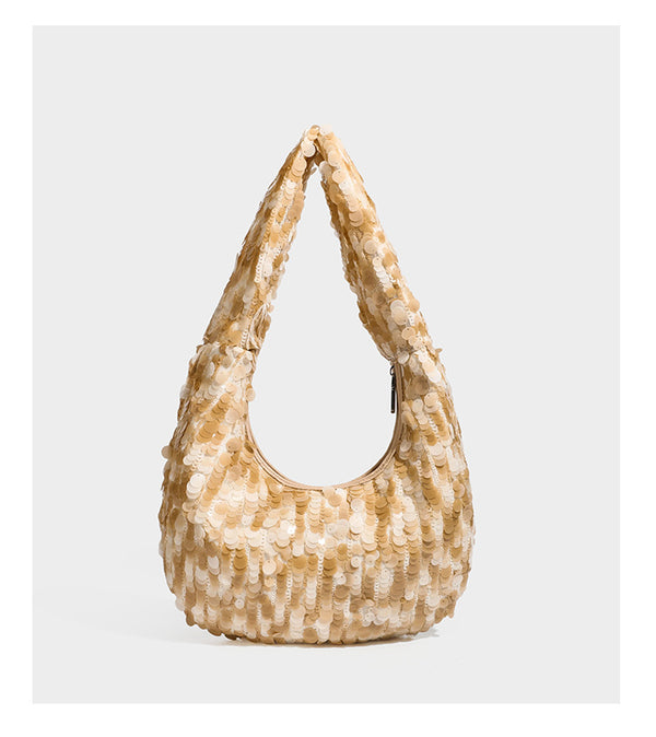 Slouchy crescent hobo shoulder bag covered in overlapping reflective sequin discs with a single integrated strap and top-zip