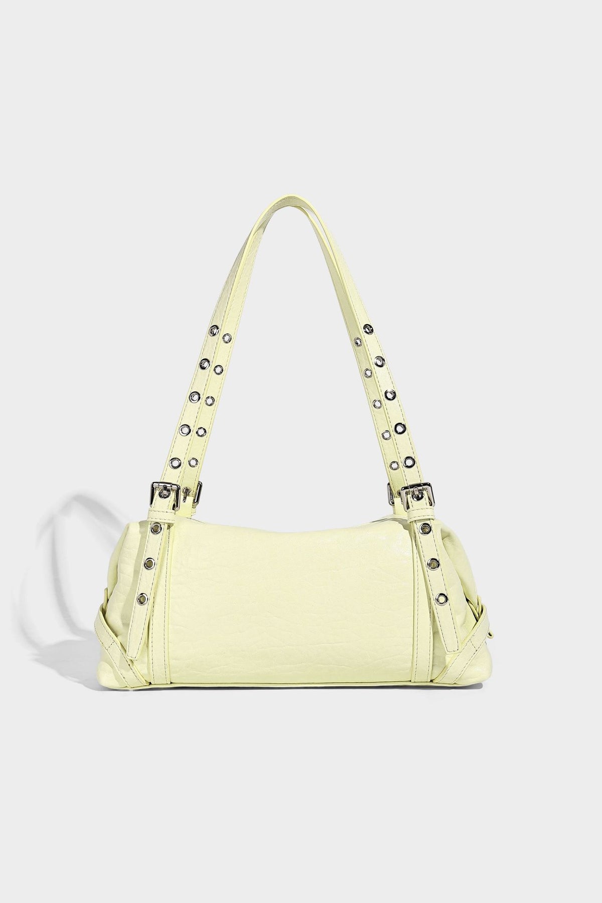Pale yellow leather-look barrel bag with silver grommet-studded shoulder straps, top zip closure, and pink tulip floral