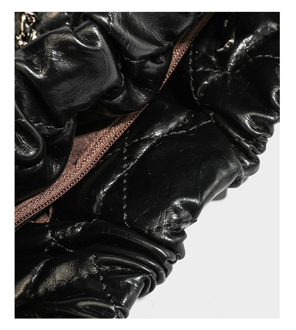 Glossy diamond-quilted drawstring bucket bag with silver chain shoulder strap and medallion charm, detail view 21
