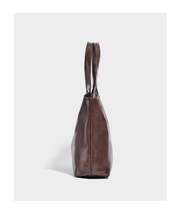 Glossy oil-wax leather-look open-top tote shoulder bag with embossed circular logo and long double straps, detail view 10