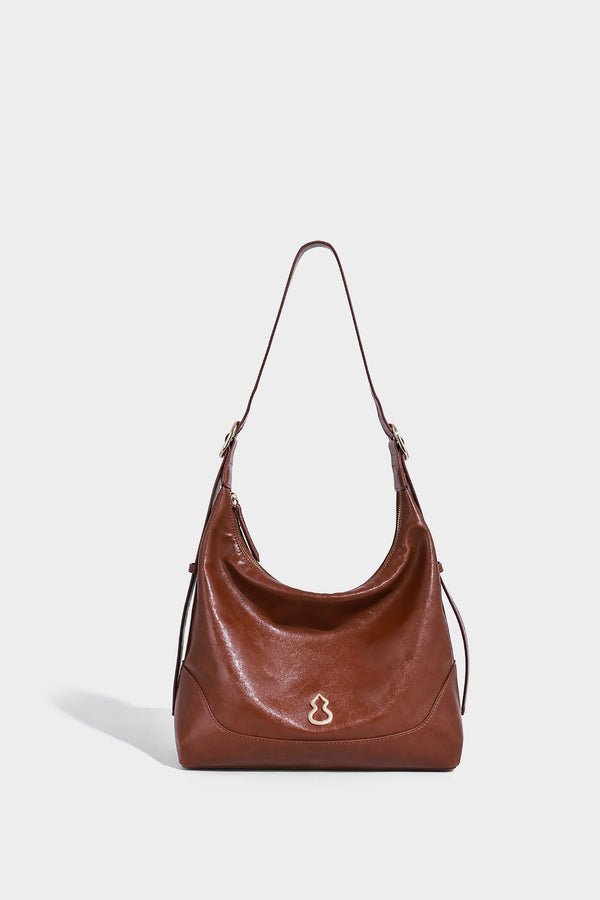 Glossy leather-look slouchy hobo shoulder bag with zip closure, gold-tone hardware, and adjustable strap, detail view 12