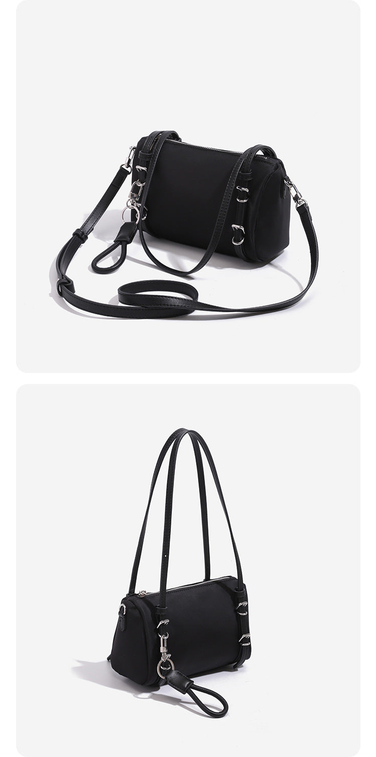 Compact nylon Boston barrel bag with zip-top closure, silver-tone hardware, dual slim handles, and detachable crossbody