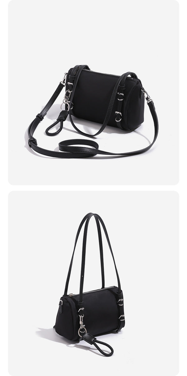 Compact nylon Boston barrel bag with zip-top closure, silver-tone hardware, dual slim handles, and detachable crossbody