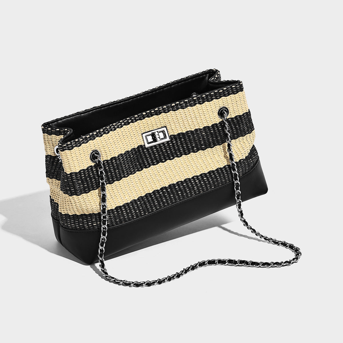 Structured black and beige striped woven shoulder bag with silver chain strap and turn-lock metal clasp, detail view 3