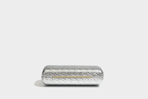 Small structured metallic woven-texture box clutch bag with jeweled kiss-lock dome clasp and slim gold chain strap, detail