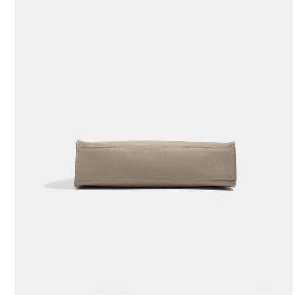 Smooth leather-look slouchy trapezoid shoulder tote with gold-tone gourd clasp hardware and long slim straps, detail view 9