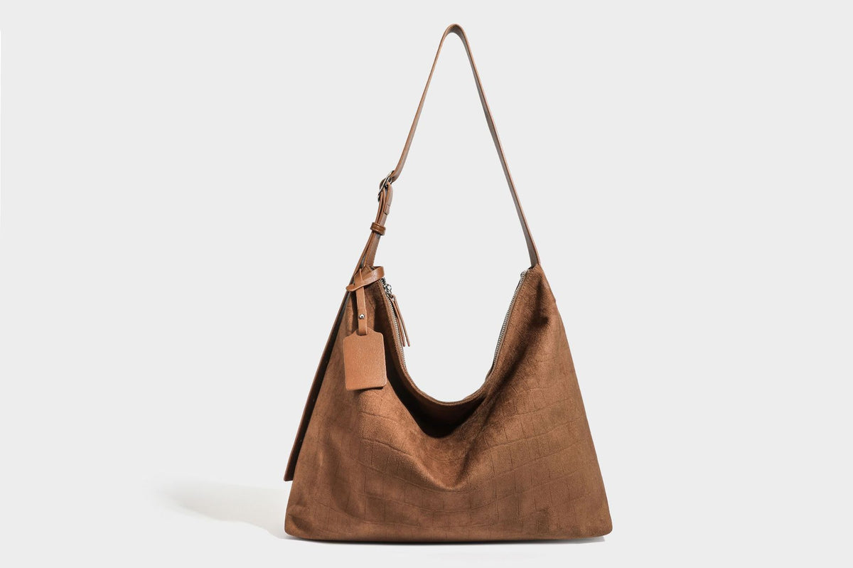 Slouchy hobo shoulder bag in matte croc-embossed leather-look finish with top zip closure and long adjustable strap, detail