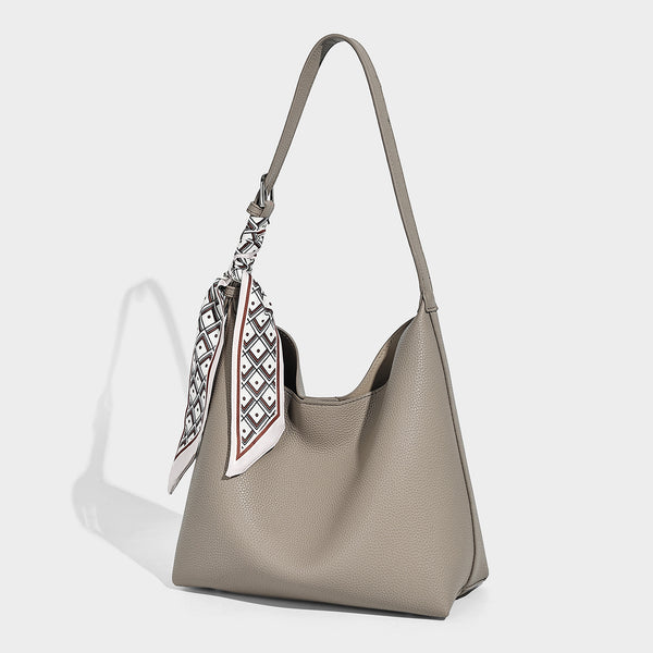 Soft slouchy hobo shoulder bag in pebbled matte finish with slim strap, silver-tone ring hardware, and knotted printed scarf