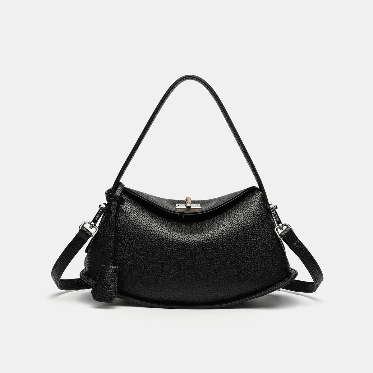 Pebbled leather-look half-moon saddle bag with turn-lock flap closure, top handle, and detachable crossbody strap, detail