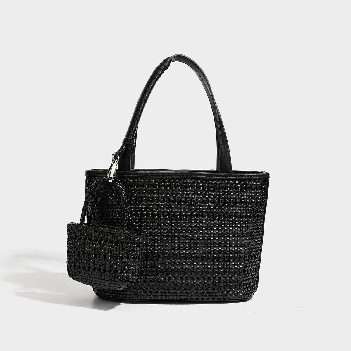 Structured open-weave tote bag with smooth leather-look trim, double top handles, detachable crossbody strap, and mini zip