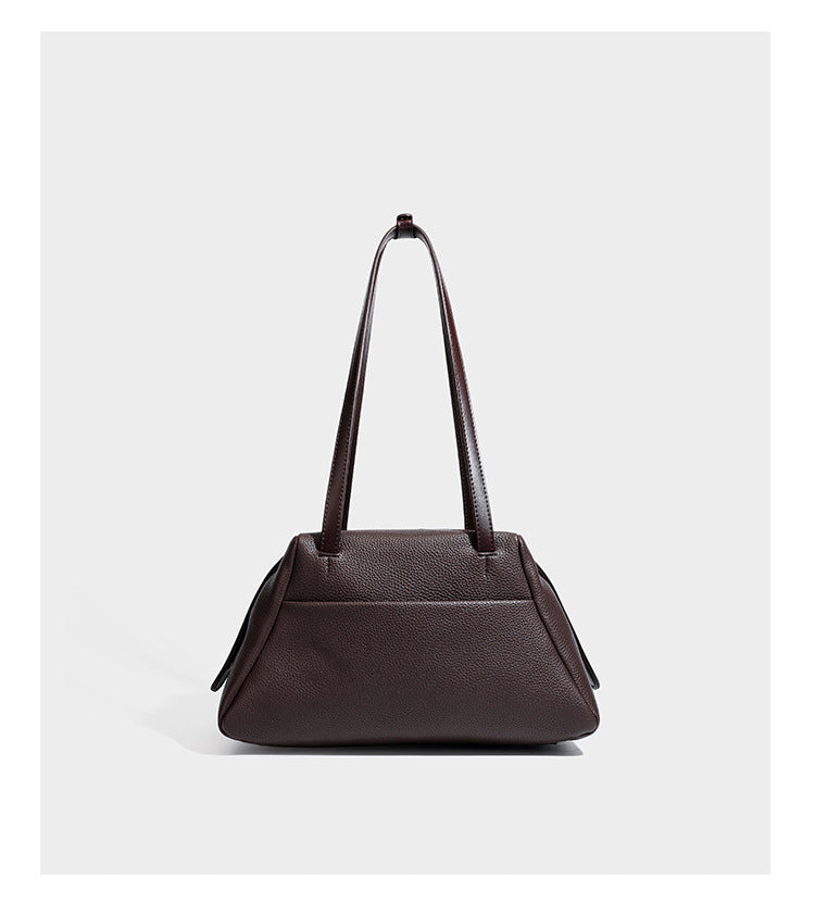 Structured trapezoid shoulder bag in dark brown pebbled leather-look finish with slim double straps, top zip closure, side