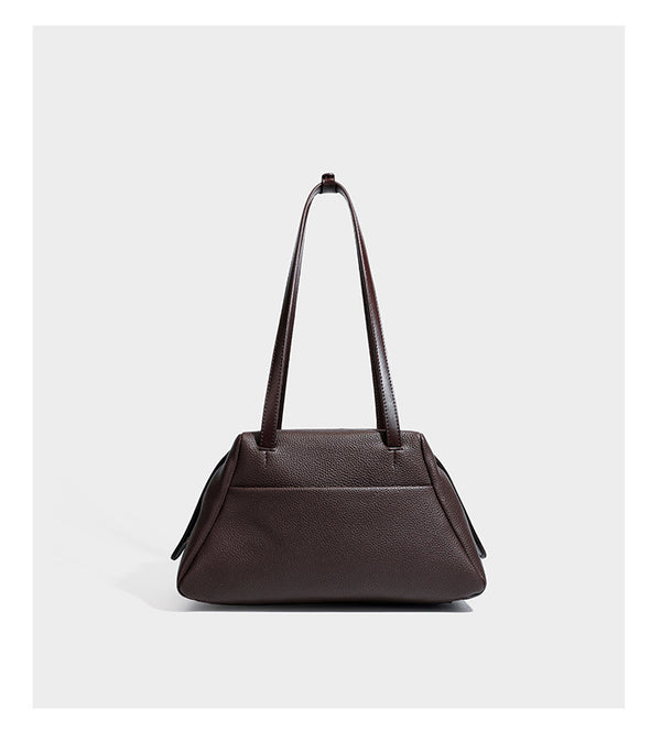 Structured trapezoid shoulder bag in dark brown pebbled leather-look finish with slim double straps, top zip closure, side