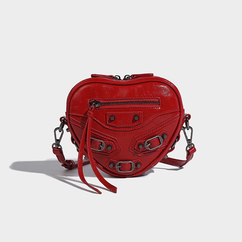 Mini heart-shaped crossbody bag with glossy crinkled finish and moto buckle hardware, detail view 2