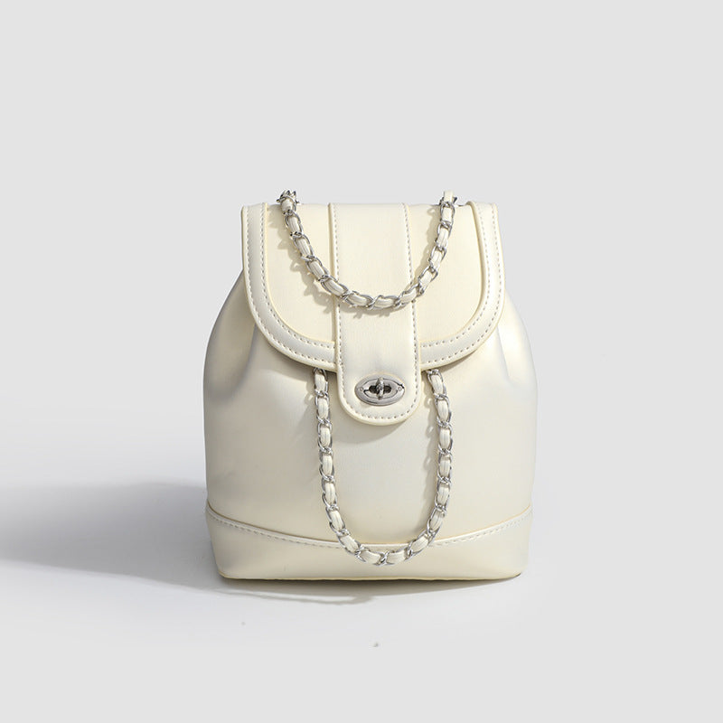 Small pearl-gloss backpack handbag with woven silver chain straps and turn-lock flap closure, detail view 7