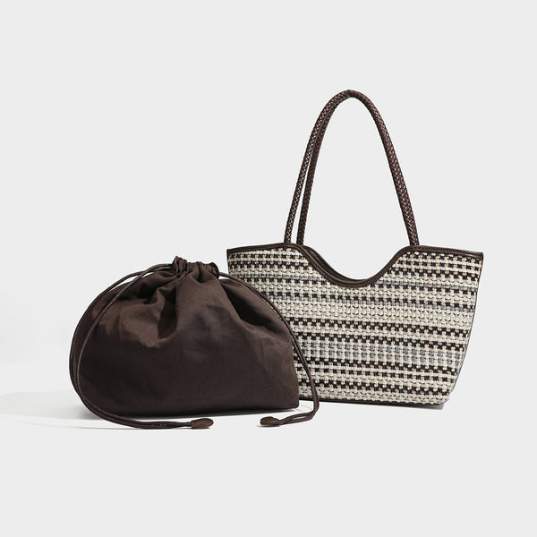 Large woven checker-pattern tote bag with dark braided shoulder straps, leather-look trim, and drawstring side ties, detail