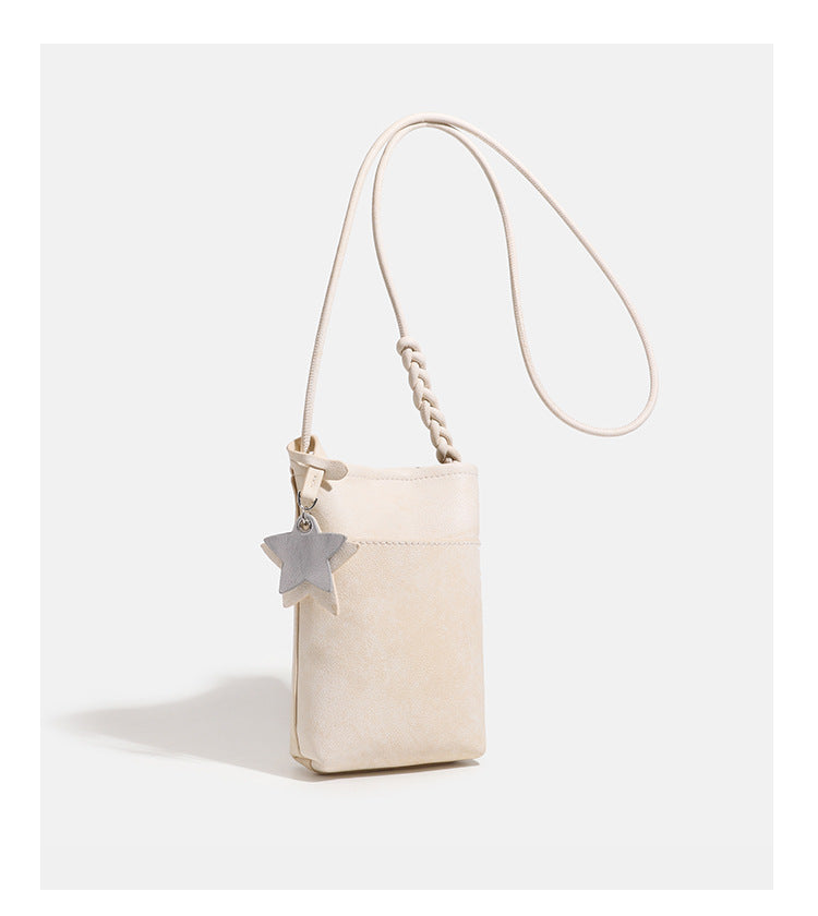 Small vertical textured mini crossbody phone bag with long braided cord strap and silver-toned star charm, detail view 15