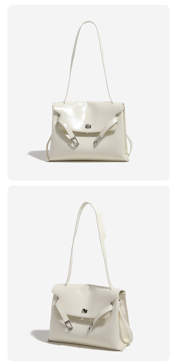Structured rectangular flap shoulder bag in glossy leather-look finish with silver-tone turn-lock closure and adjustable