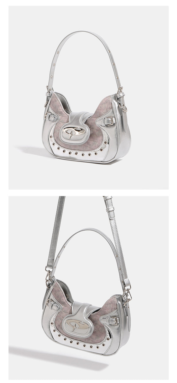 Compact croc-embossed leather-look shoulder bag with silver grommet trim, buckle strap detail, and four-point star turn-lock
