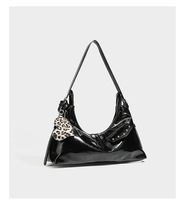 Glossy dark brown hobo shoulder bag with slim strap, front zip pocket, stud detail, and detachable leopard-print heart charm
