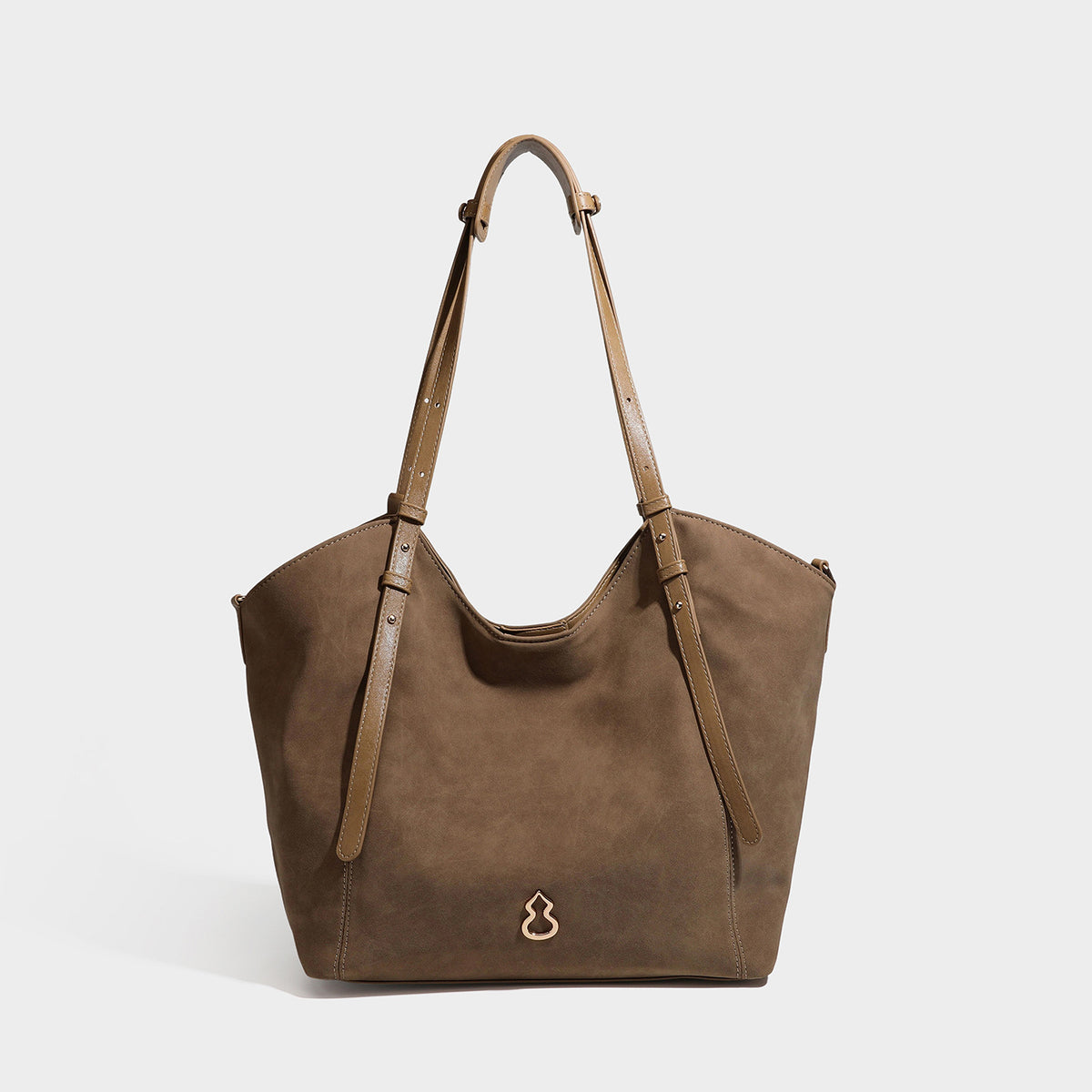 Oversized suede-finish tote shoulder bag in caramel brown with slim leather-look straps and gold-tone logo hardware, detail